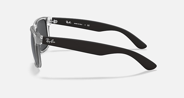 Ray-Ban Justin sunglasses, side profile with clear frame and dark gray lenses.