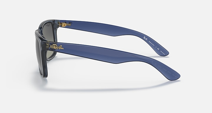 Blue sunglasses with dark lenses and matching blue temple arms