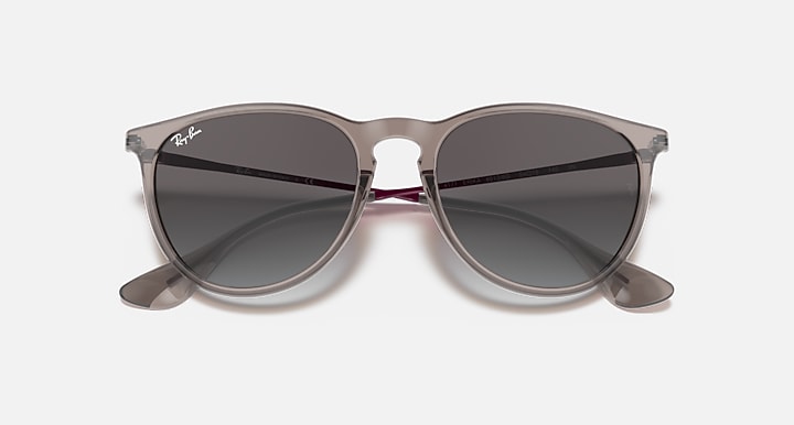 Sunglasses with taupe frame and dark gradient lenses, curved arms and nose bridge
