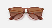 Brown sunglasses with gradient brown lenses and curved cat-eye profile