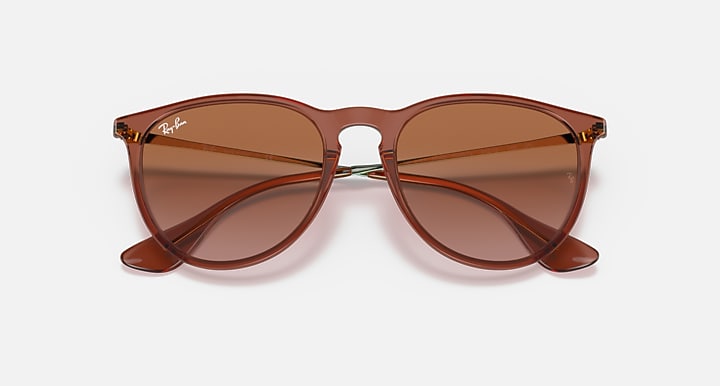 Brown sunglasses with gradient brown lenses and curved cat-eye profile