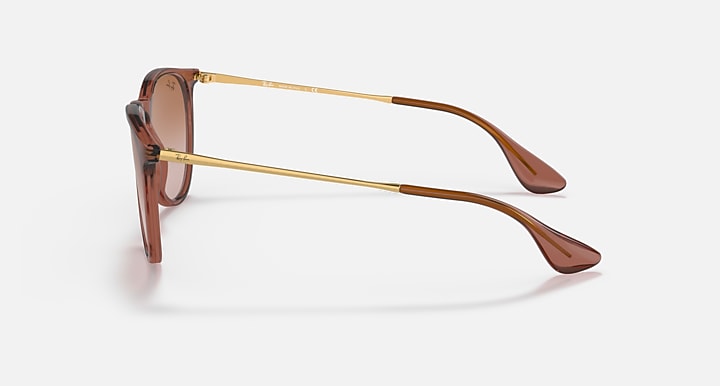 Brown translucent sunglasses with gold-tone metal temples and gradient lenses