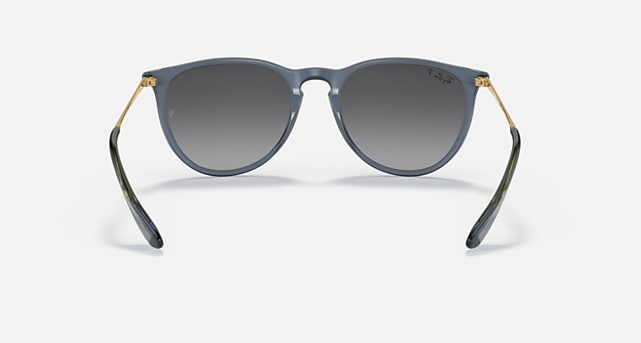 Blue-gray sunglasses with dark gradient lenses and gold-tone metal accents