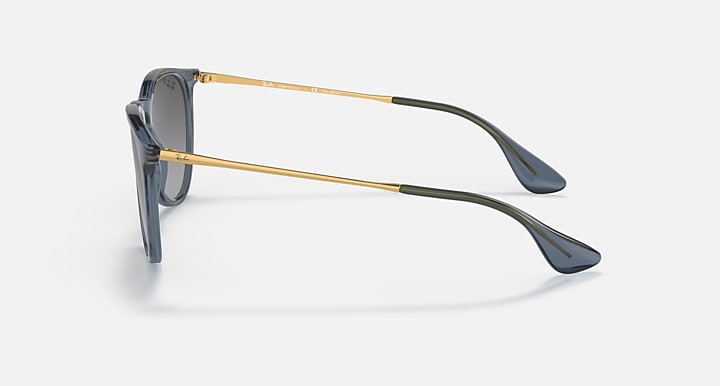 Blue-gray sunglasses with gold-tone metal temples and dark gradient lenses