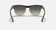 Oversized black browline sunglasses with dark lenses, gold-tone bridge and hinges