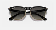 Oversized black sunglasses with dark lenses and gold-tone detailing, symmetrical front view