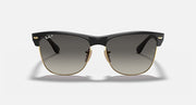 Oversized black browline sunglasses with dark lenses and gold-tone hinges, front view