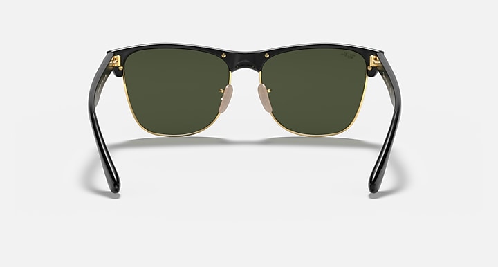 Oversized black browline sunglasses with green lenses, gold-tone bridge and hinges