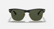 Oversized black browline sunglasses with green lenses and gold-tone hinges, front view