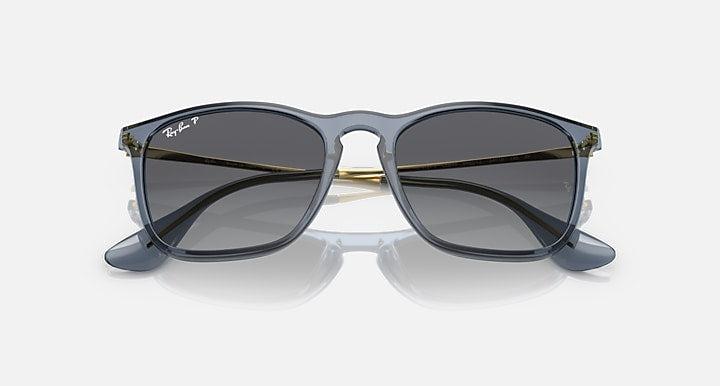 Ray-Ban square-style sunglasses with blue-gray frame, dark lenses, and gold accents