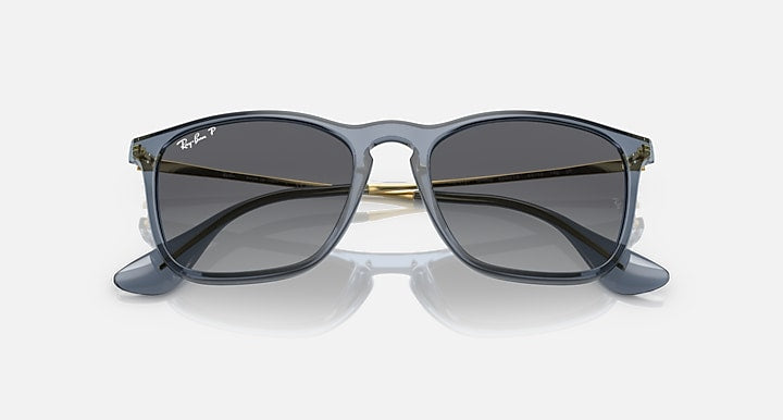 Cat-eye style sunglasses with dark lenses, black frame, and gold-tone bridge hardware
