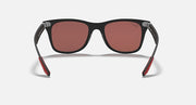 Black Ray-Ban sunglasses with pink lenses, temples showing red accents