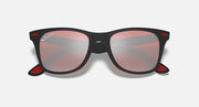 Black Ray-Ban sunglasses with pink tinted lenses, angled front view