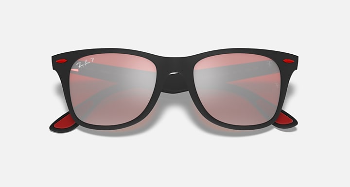 Black Ray-Ban sunglasses with pink tinted lenses, angled front view