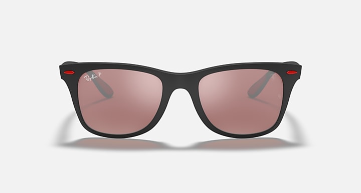 Black Ray-Ban sunglasses with pink lenses and red accents, straight-on view