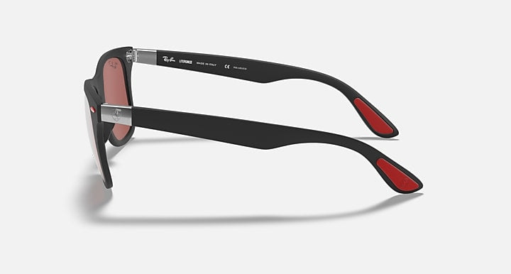 Black Ray-Ban sunglasses side profile with pink lens and red temple tips