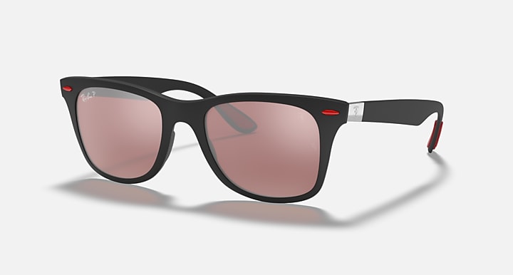 Black Ray-Ban sunglasses with pink tinted lenses and red hinge accents, front view