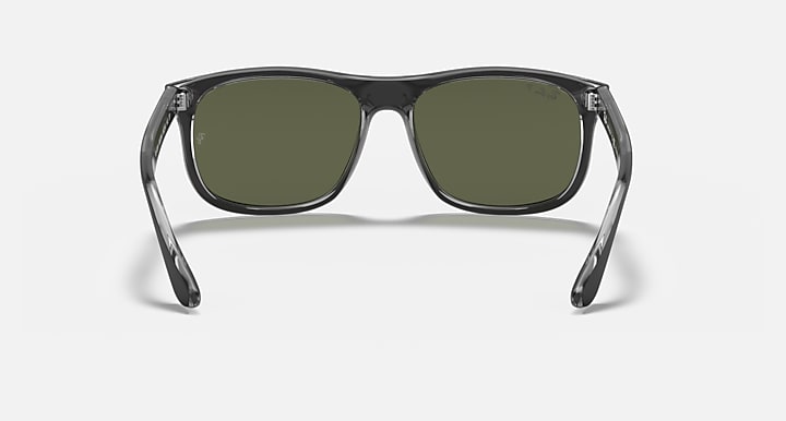 Front view sunglasses with see-through frame accents and green tinted lenses.