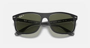 Black sunglasses with green lenses and Ray-Ban branding on the temple arms.