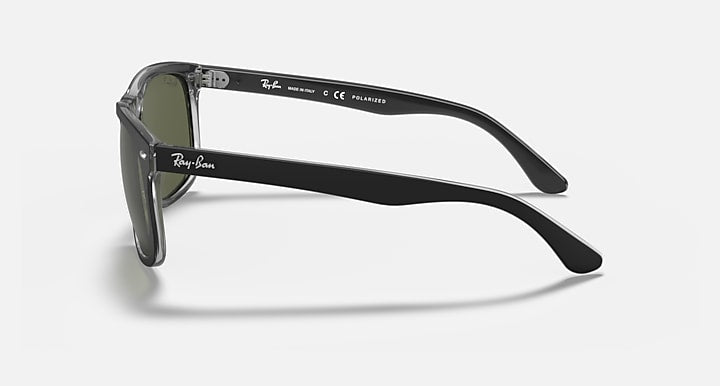 Black sunglasses side view with clear temple accents and Ray-Ban logo.