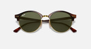 Round sunglasses with dark green lenses, tortoise brown frame and gold-tone nose bridge