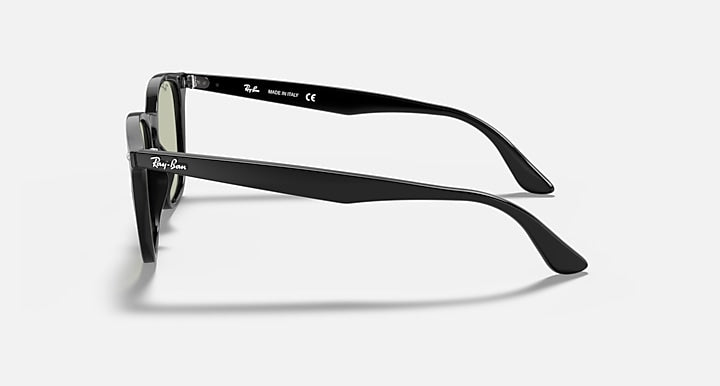 Ray-Ban sunglasses side profile with dark frame and green tinted lens, slim temple