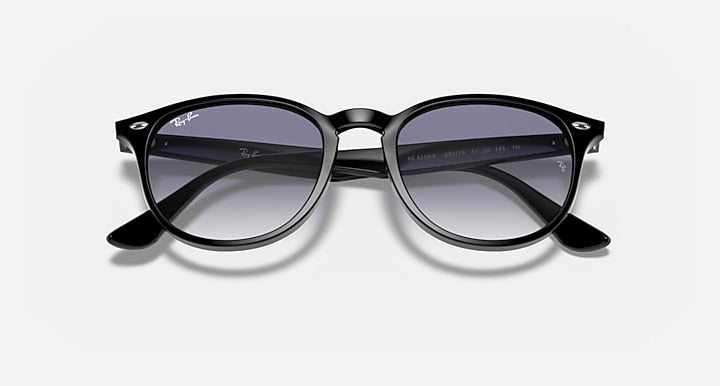 Black sunglasses with large round lenses and dark gradient tint, temple branding