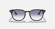 Black sunglasses with large round lenses and glossy finish, dark gradient tint