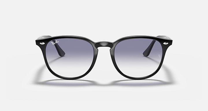 Black sunglasses with large round lenses and glossy finish, dark gradient tint