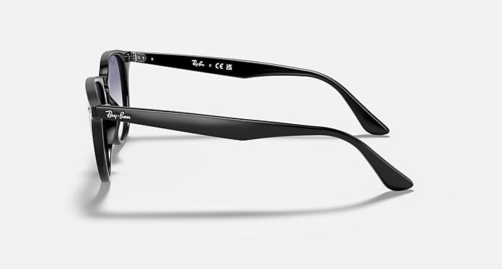 Black sunglasses, side profile with slim arms and dark tinted lenses
