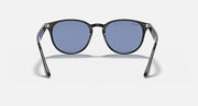Oversized round sunglasses with dark frame and blue-tinted lenses, front view