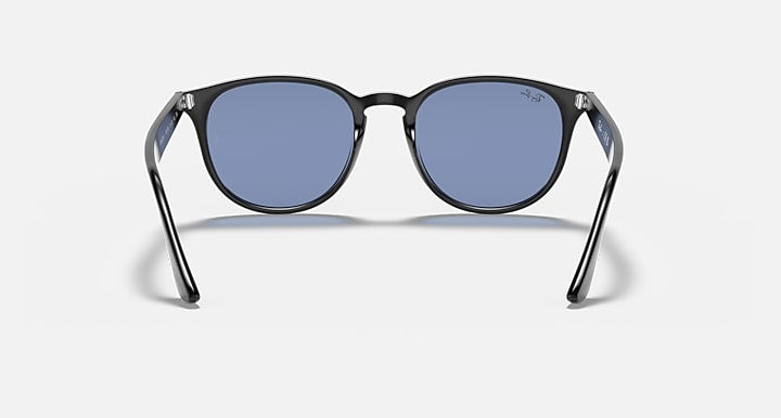 Oversized round sunglasses with dark frame and blue-tinted lenses, front view