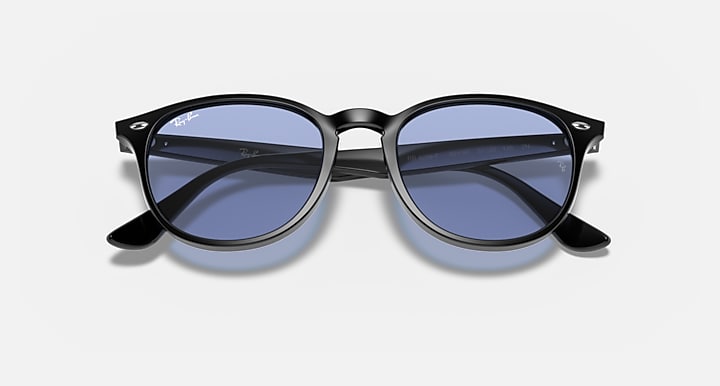 Black oversized round sunglasses with blue-tinted lenses and curved side arms