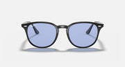 Dark oversized round sunglasses with blue-tinted lenses and slim front bridge