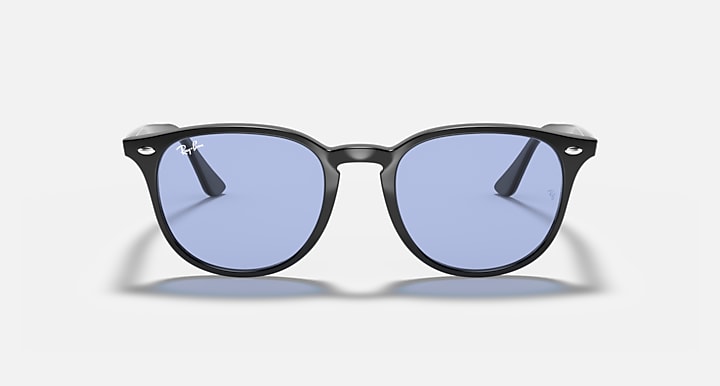 Dark oversized round sunglasses with blue-tinted lenses and slim front bridge