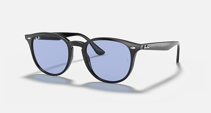 Black oversized round sunglasses with blue-tinted lenses and wide bridge