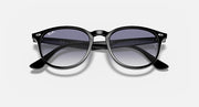 Ray-Ban RB4259 round sunglasses with black frame and purple tinted lenses, front close