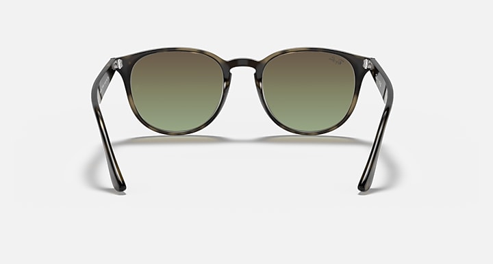 Sunglasses with dark frames and green-tinted lenses, round profile