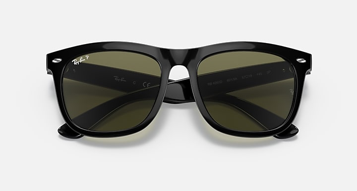 Black sunglasses with olive tinted lenses and centered nose bridge
