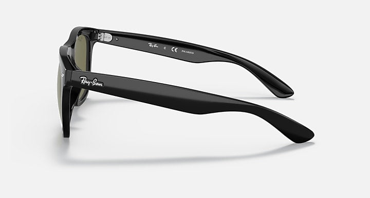 Black side-profile sunglasses with olive lenses and curved temples