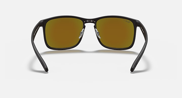 Black rectangular sunglasses with gold mirrored lenses and Ray-Ban logo