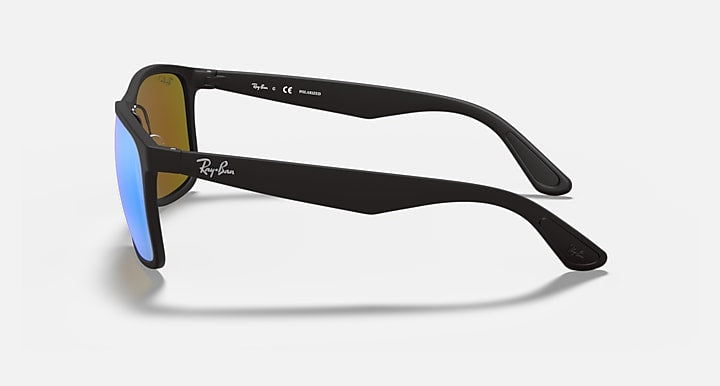 Black sunglasses side profile with blue mirrored lenses and Ray-Ban logo