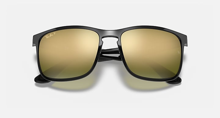 Sunglasses with black frame and gold mirrored rectangular lenses