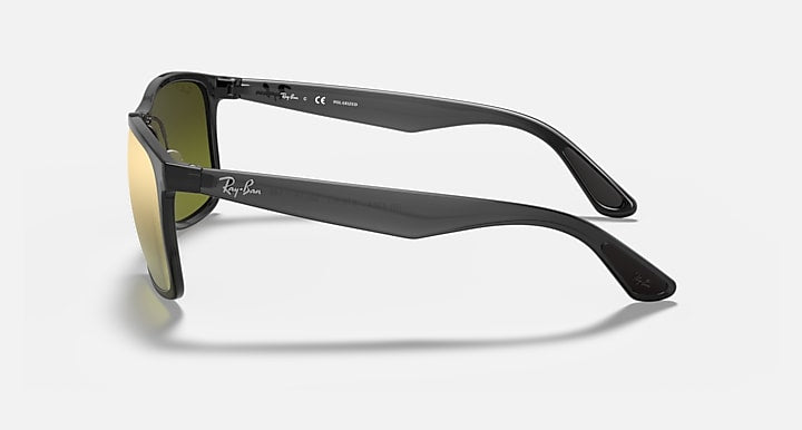 Sunglasses with black frame and green mirrored lenses, side profile