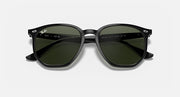 Ray-Ban hexagonal sunglasses with dark frames and green tinted lenses, angled front