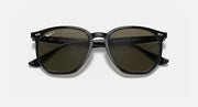 Black hexagonal sunglasses with dark green tinted lenses and curved temples