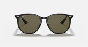 Black hexagonal sunglasses with olive green tinted lenses and glossy black frame