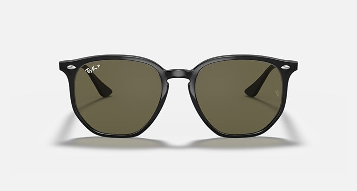 Black hexagonal sunglasses with olive green tinted lenses and glossy black frame