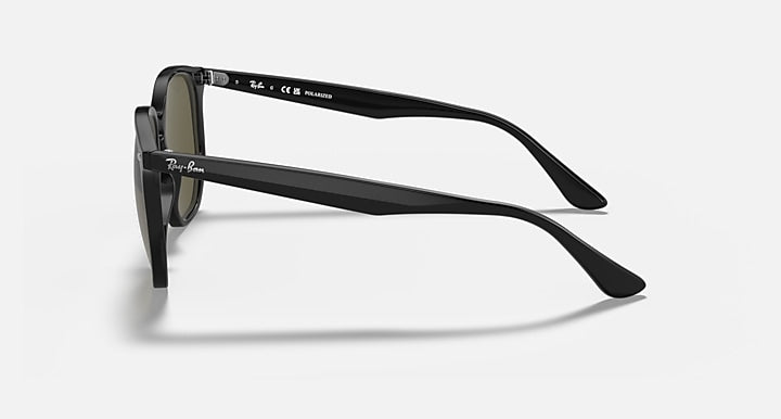 Black sunglasses frame shown from the side with dark-tinted lenses and temples