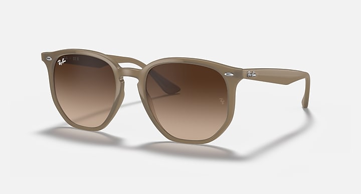 Light tan hexagonal sunglasses with brown tinted lenses and slim arms